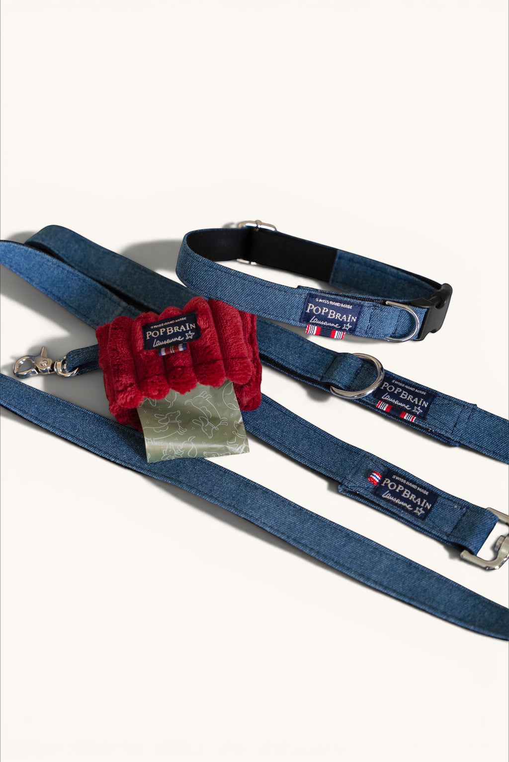 Popbrain denim dog leash and collar set with a red waste bag holder, handmade in Lausanne with indigo denim fabric.