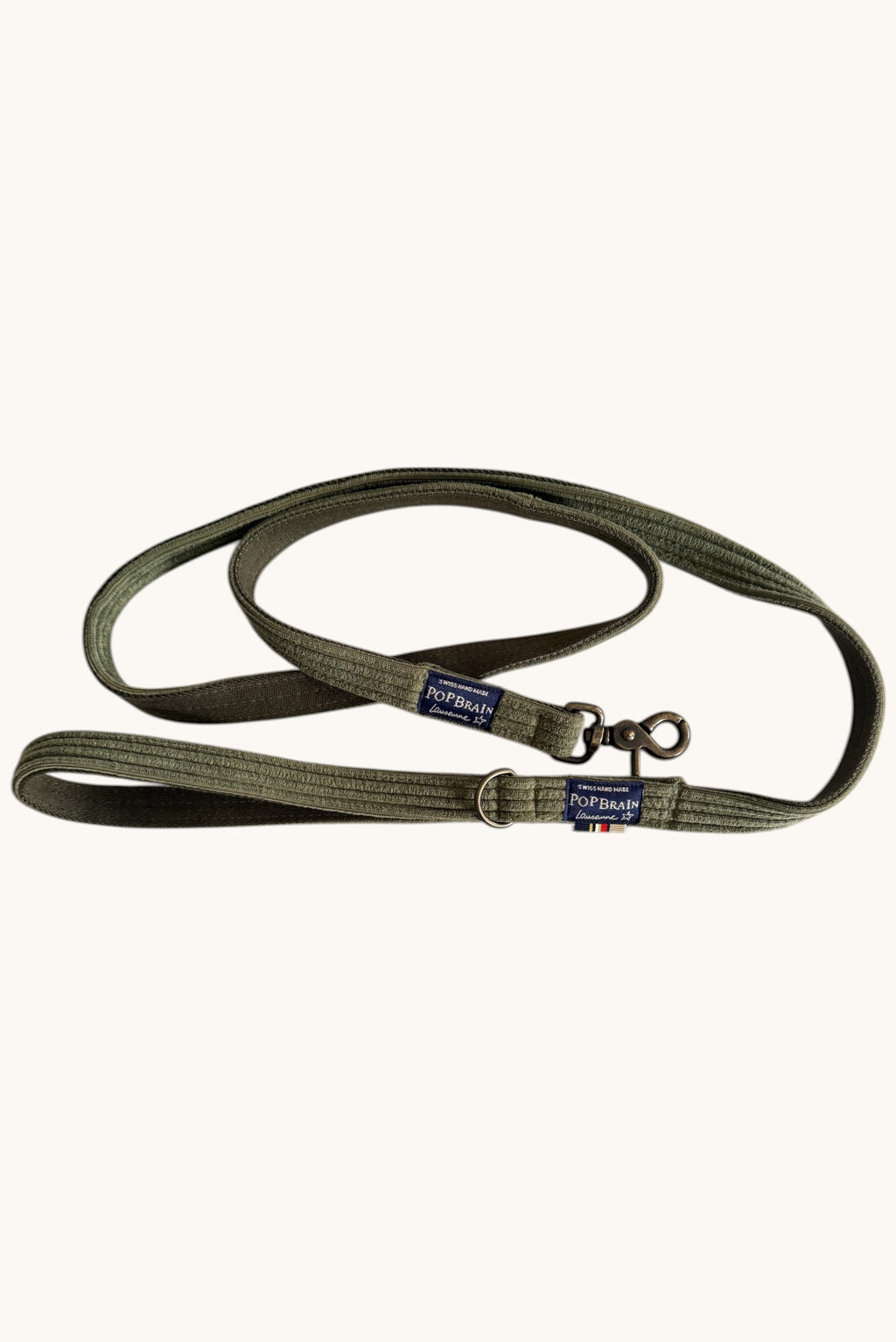 Popbrain Olive dog leash in khaki corduroy fabric with an antique bronze clasp and Swiss-made branding label.