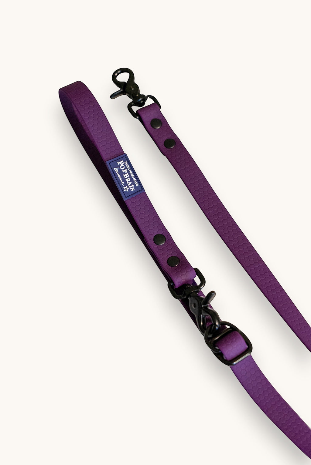 Popbrain purple waterproof PVC dog leash with honeycomb texture and matte black hardware on a white background.