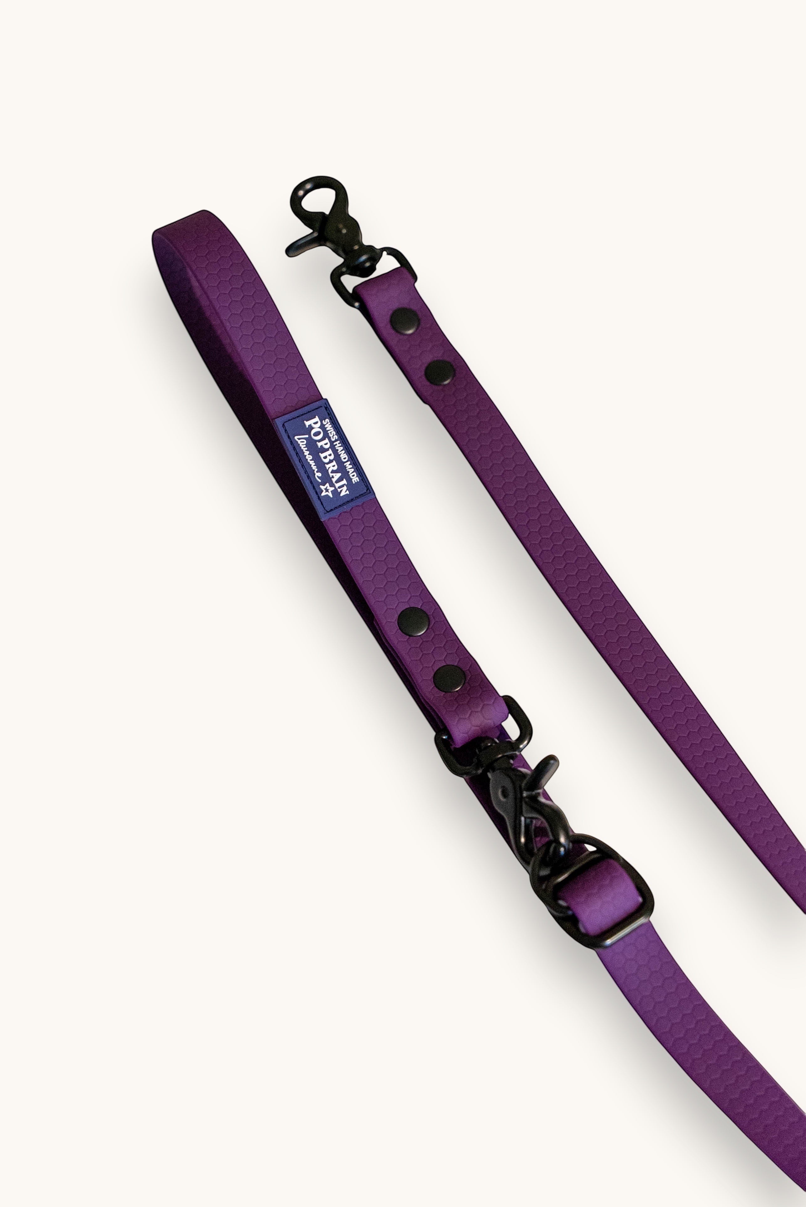 Popbrain purple waterproof PVC dog leash with honeycomb texture and matte black hardware on a white background.