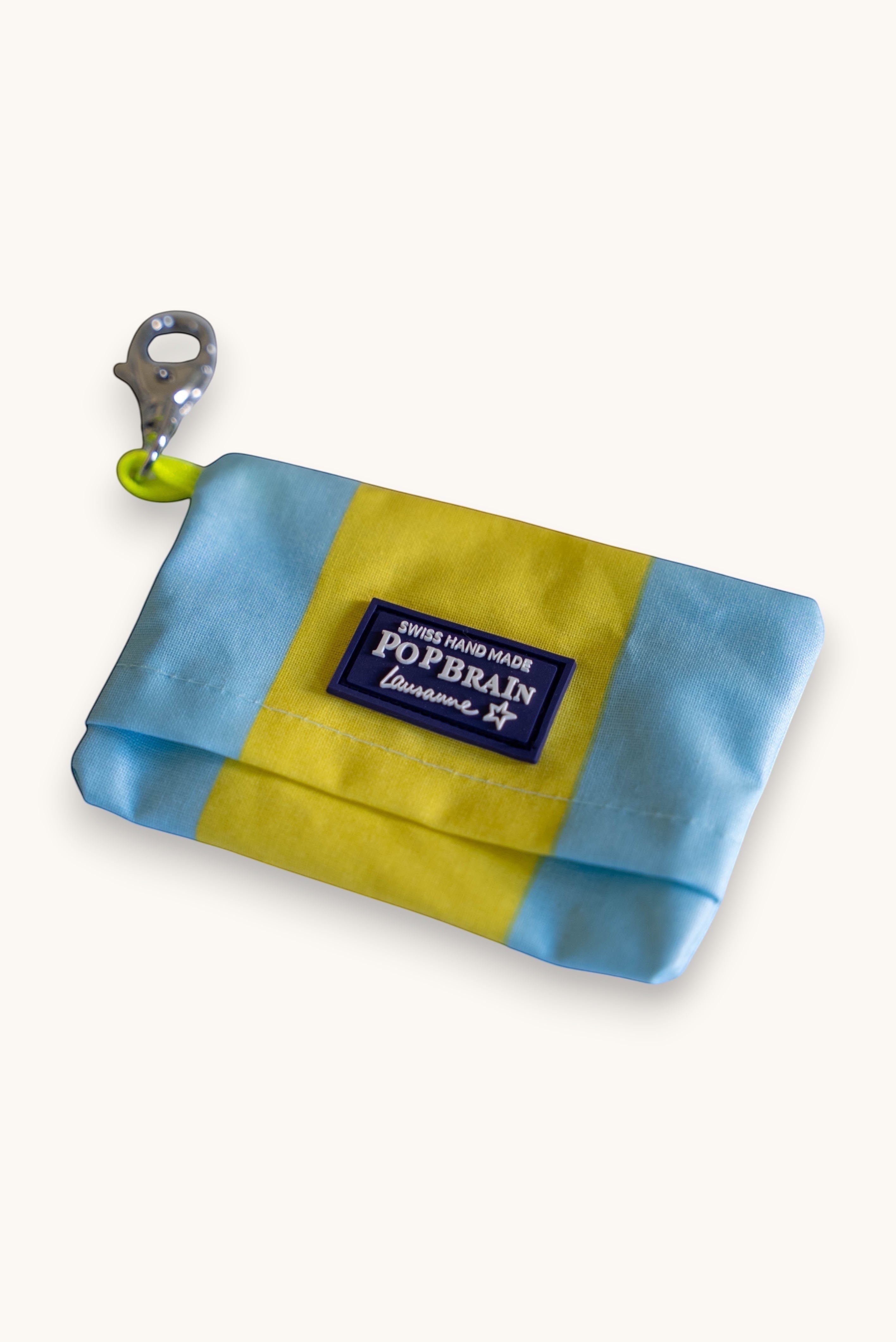 Popbrain waterproof PVC dog waste bag holder in yellow and light blue with a silver clip and branded rubber patch
