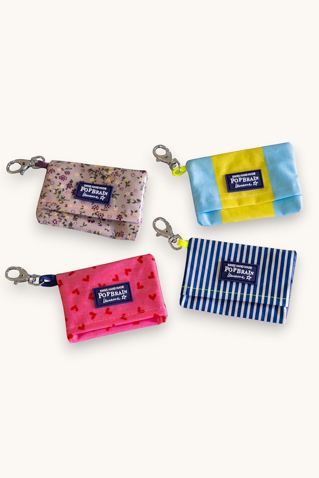 Popbrain waterproof PVC dog waste bag holders in floral, striped, and heart patterns with metal clips.