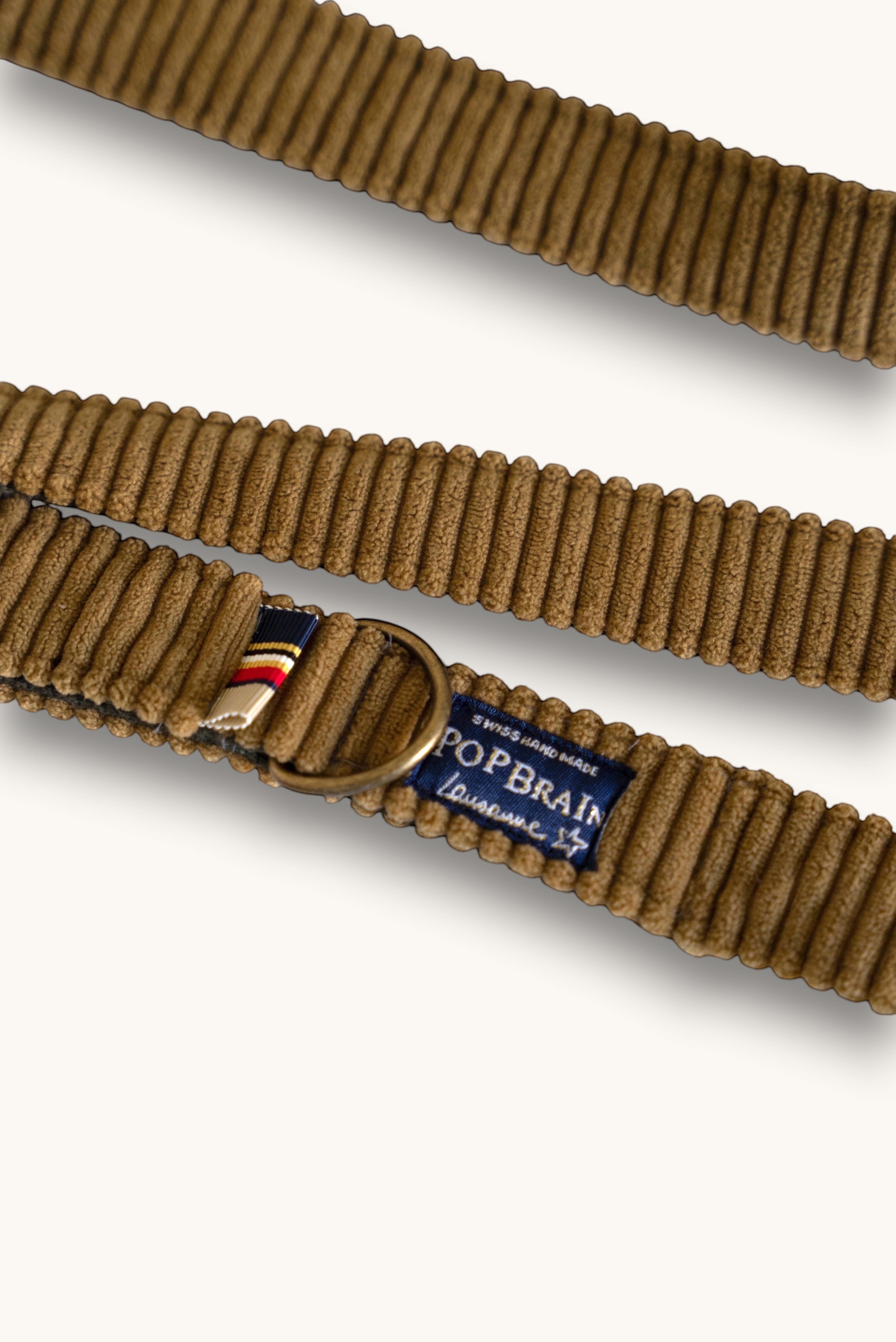 Popbrain Safari dog leash in camel corduroy fabric with antique bronze hardware and a Swiss-made brand label.