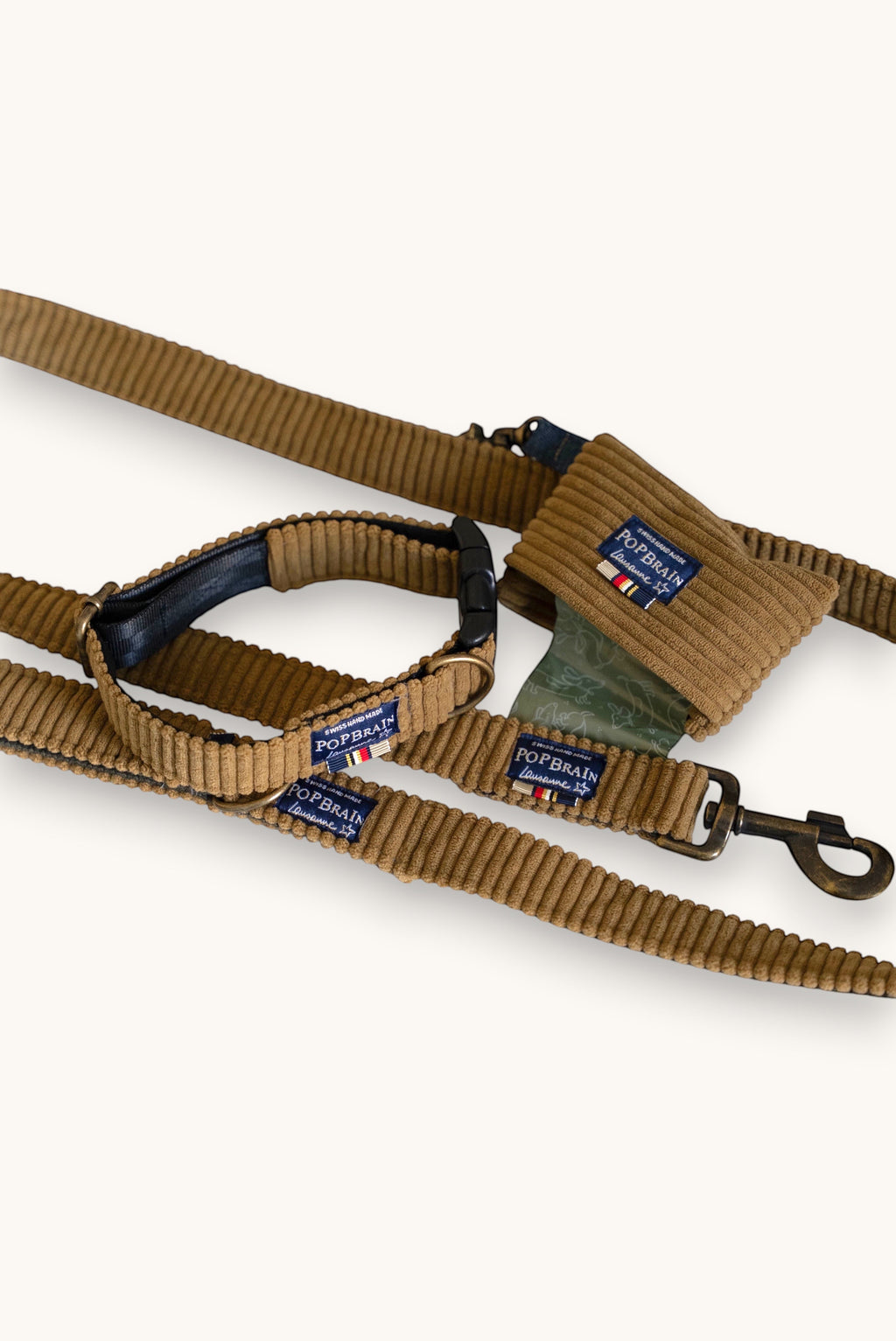 Popbrain Safari set featuring a camel corduroy dog leash, matching collar, and waste bag holder with bronze hardware.