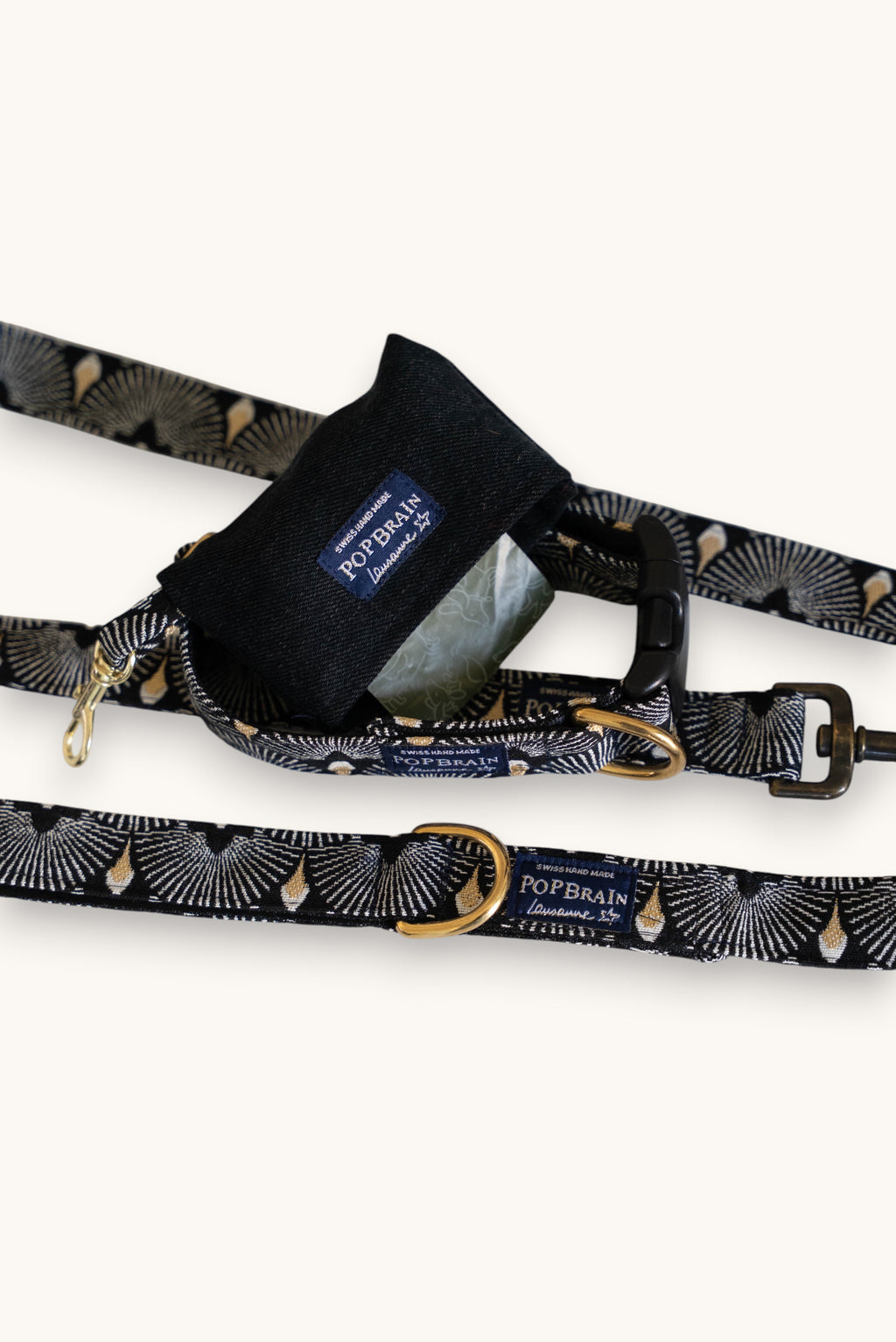 Popbrain Tokyo collection black faux leather dog waste bag dispenser with gold hardware clipped to matching leash