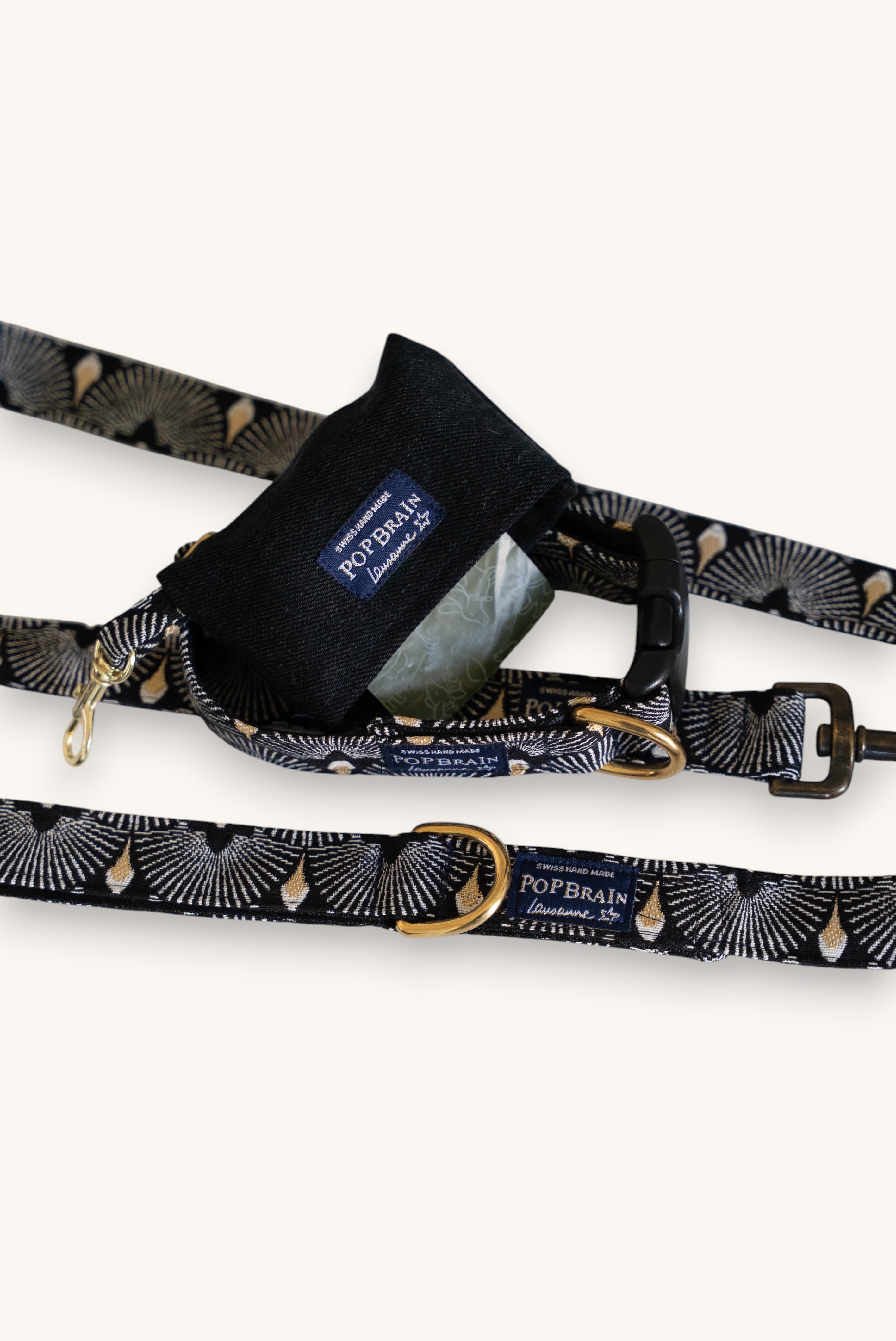 Popbrain Tokyo collection black faux leather dog waste bag dispenser with gold hardware clipped to matching leash