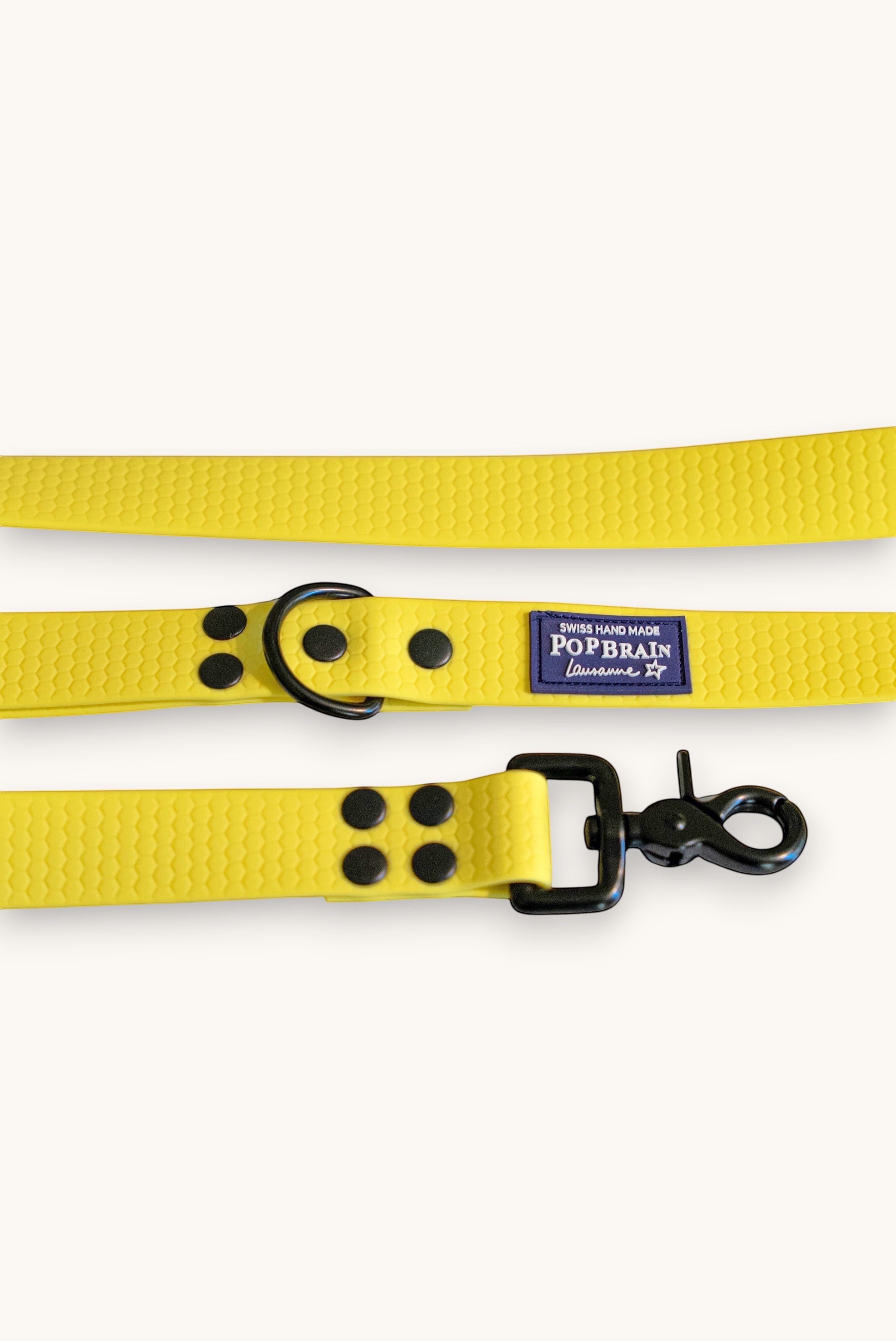 Popbrain yellow waterproof PVC dog leash with honeycomb texture, black matte hardware, and Swiss-made branding label.